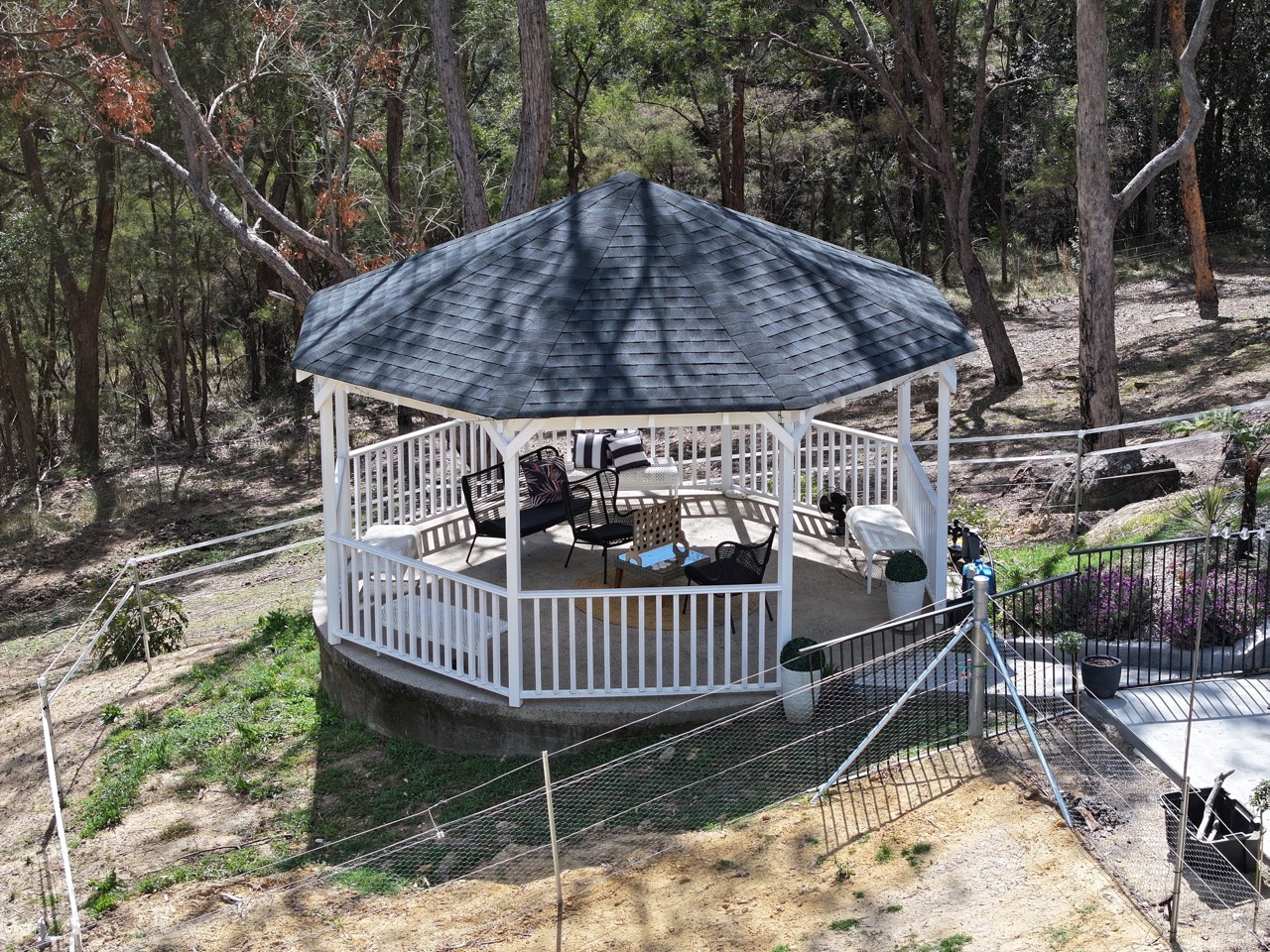 White timber gazebo in a bush setting