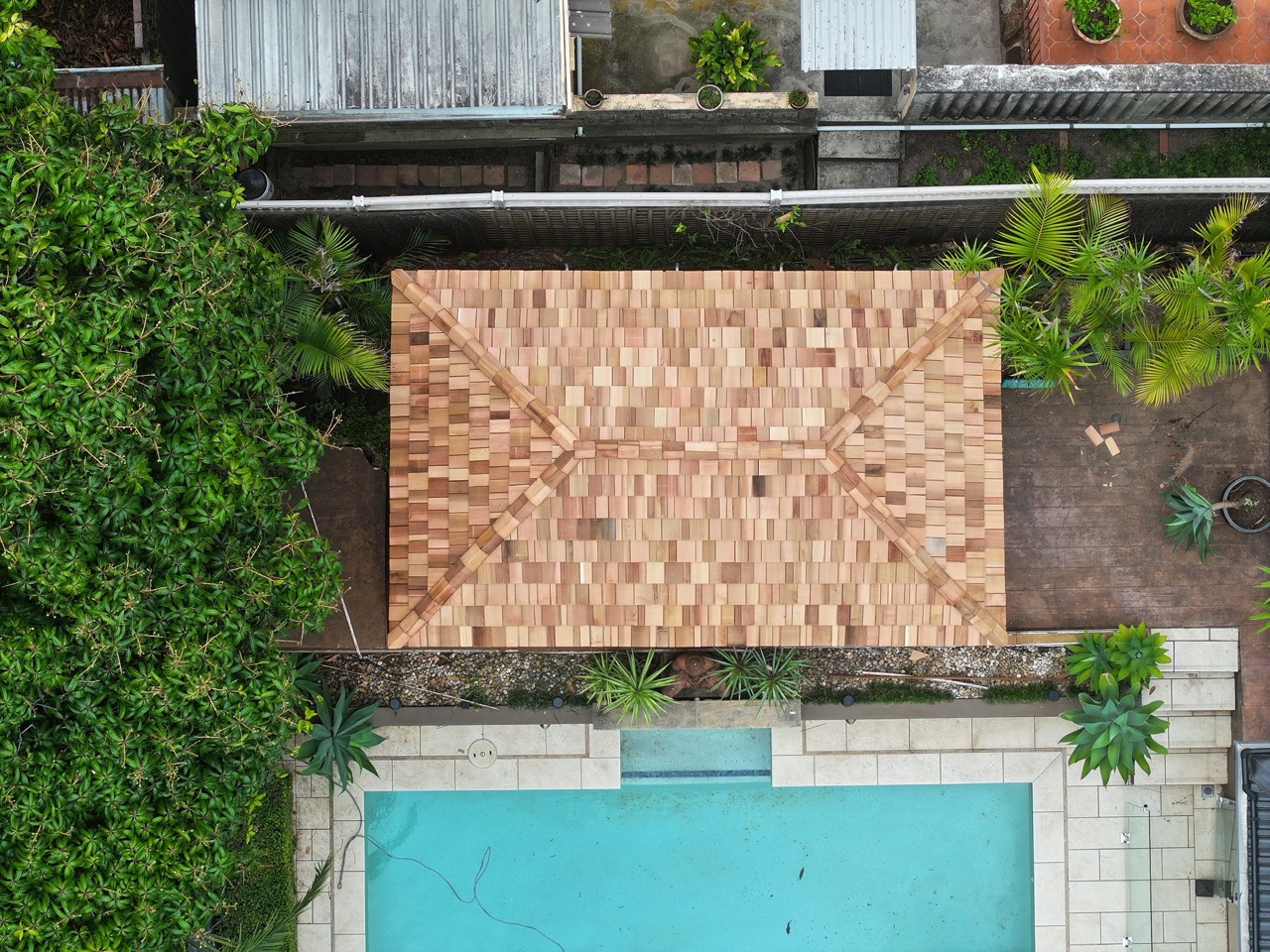 Aerial of a cedar shingle gazebo by a pool